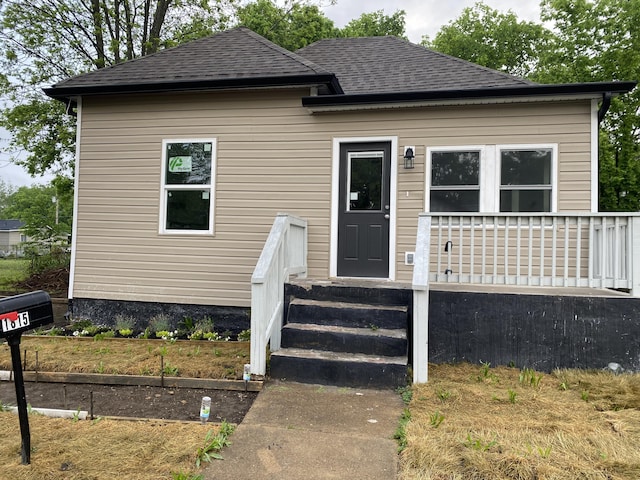 bungalow featuring a shingled roof