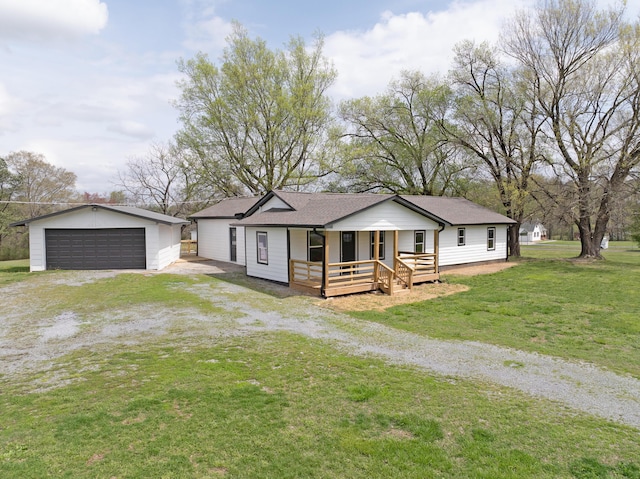 view of front facade with an outdoor structure, a detached garage, a front lawn, a porch, and a shingled roof