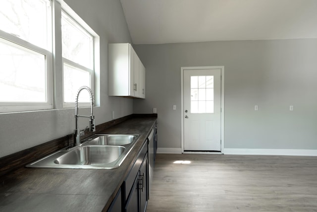 kitchen with a healthy amount of sunlight, a sink, and dark countertops