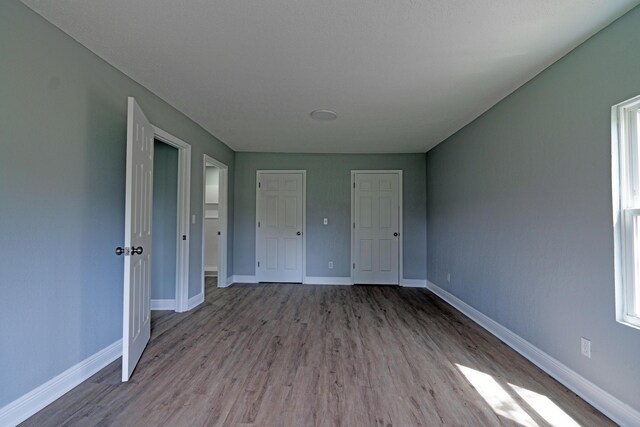 interior space featuring baseboards and wood finished floors