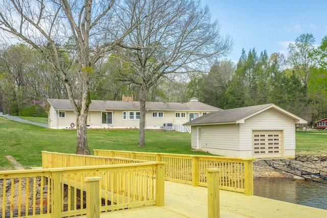 2041 Linwood Cir, Soddy Daisy, TN 37379 - wooden terrace featuring a garage, a water view, an outdoor structure, and a lawn