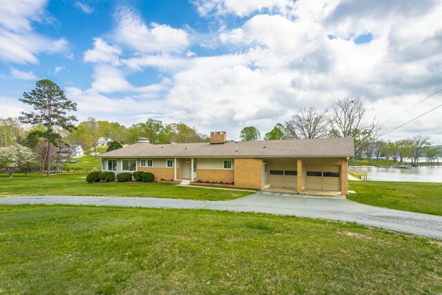 2041 Linwood Cir, Soddy Daisy, TN 37379 - view of front of home with a front yard, a chimney, an attached garage, and aphalt driveway