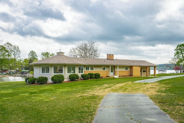 2041 Linwood Cir, Soddy Daisy, TN 37379 - view of front of house featuring a water view, a chimney, and a front lawn