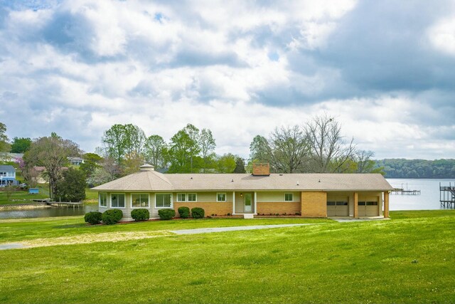 2041 Linwood Cir, Soddy Daisy, TN 37379 - ranch-style house featuring a chimney, driveway, a garage, a front yard, and a water view