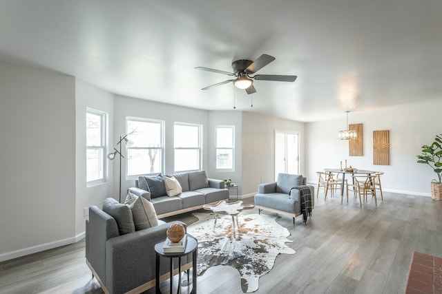 2041 Linwood Cir, Soddy Daisy, TN 37379 - living room featuring ceiling fan with notable chandelier, baseboards, and wood finished floors