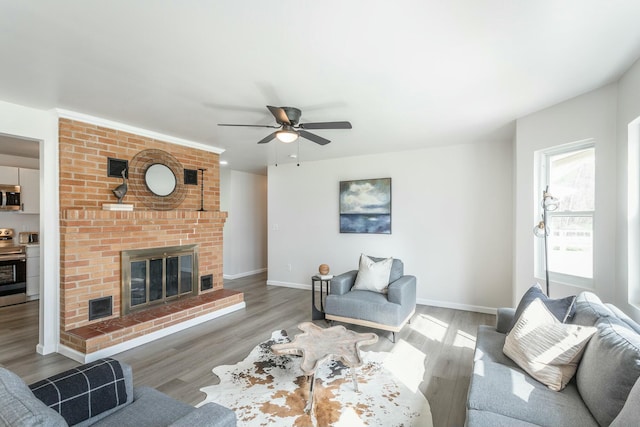 2041 Linwood Cir, Soddy Daisy, TN 37379 - living area with a fireplace, baseboards, a ceiling fan, and wood finished floors