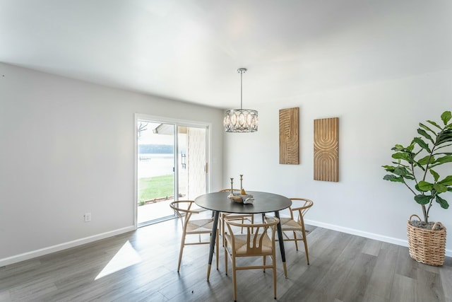 2041 Linwood Cir, Soddy Daisy, TN 37379 - dining area with a chandelier, dark wood-style floors, and baseboards