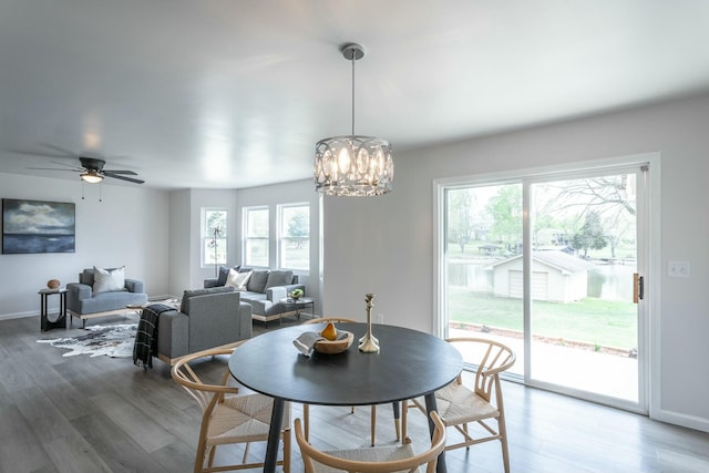2041 Linwood Cir, Soddy Daisy, TN 37379 - dining area featuring baseboards, wood finished floors, and ceiling fan with notable chandelier