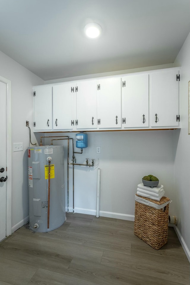 2041 Linwood Cir, Soddy Daisy, TN 37379 - washroom featuring electric water heater, baseboards, cabinet space, and wood finished floors