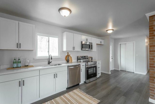 2041 Linwood Cir, Soddy Daisy, TN 37379 - kitchen featuring white cabinets, a sink, light countertops, wood finished floors, and stainless steel appliances