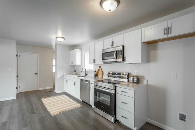 2041 Linwood Cir, Soddy Daisy, TN 37379 - kitchen featuring stainless steel appliances, light countertops, a sink, and white cabinetry
