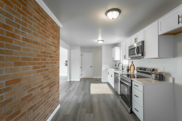 2041 Linwood Cir, Soddy Daisy, TN 37379 - kitchen featuring baseboards, white cabinets, dark wood-style flooring, light countertops, and appliances with stainless steel finishes