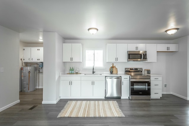2041 Linwood Cir, Soddy Daisy, TN 37379 - kitchen featuring visible vents, a sink, electric water heater, white cabinetry, and stainless steel appliances