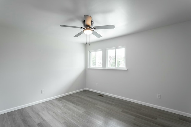 2041 Linwood Cir, Soddy Daisy, TN 37379 - spare room with dark wood-type flooring, visible vents, baseboards, and ceiling fan