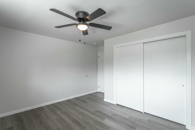 2041 Linwood Cir, Soddy Daisy, TN 37379 - unfurnished bedroom featuring a closet, baseboards, a ceiling fan, and wood finished floors