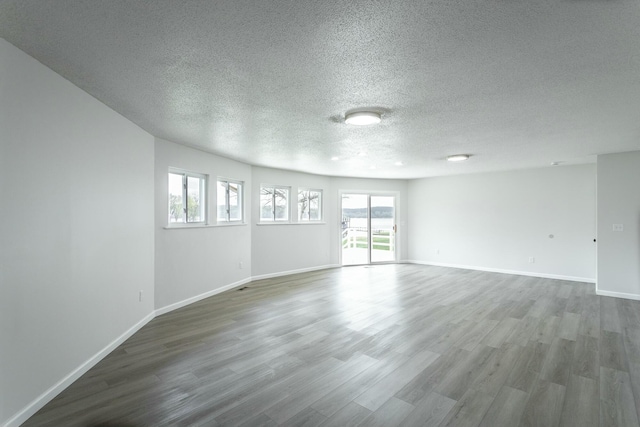 2041 Linwood Cir, Soddy Daisy, TN 37379 - unfurnished room with a textured ceiling, baseboards, and dark wood-style floors