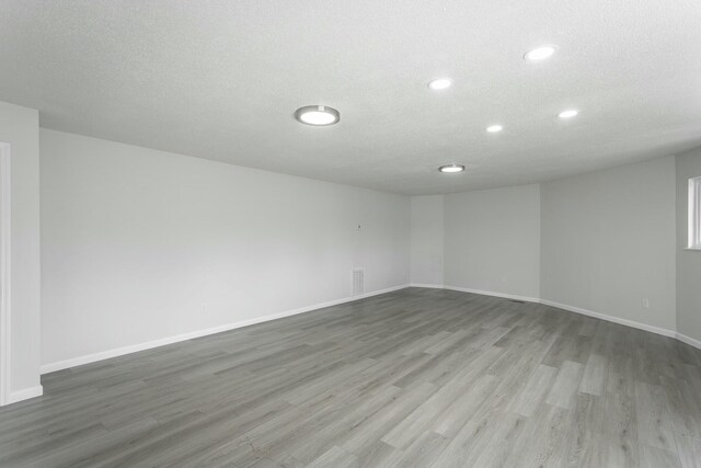 2041 Linwood Cir, Soddy Daisy, TN 37379 - empty room featuring visible vents, baseboards, wood finished floors, and a textured ceiling