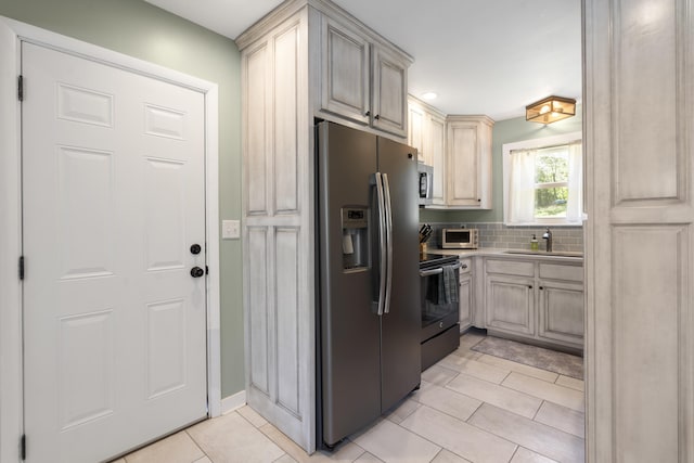 811 Snow St, Chattanooga, TN 37405 - kitchen featuring tasteful backsplash, a sink, light tile patterned floors, stainless steel appliances, and recessed lighting