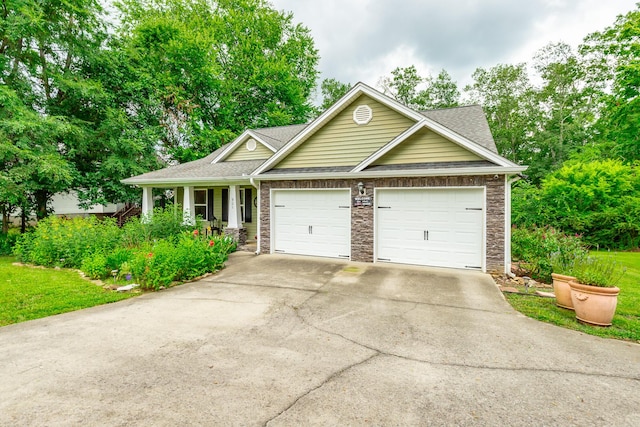 901 Haggard Rd, Ringgold, GA 30736 - view of front facade featuring driveway, a garage, a shingled roof, stone siding, and a porch