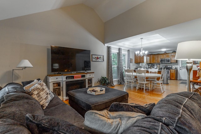 901 Haggard Rd, Ringgold, GA 30736 - living room with a chandelier, light wood-type flooring, lofted ceiling, and a tray ceiling