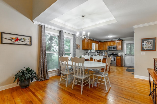 901 Haggard Rd, Ringgold, GA 30736 - dining area with crown molding, a tray ceiling, a chandelier, and light wood-style floors