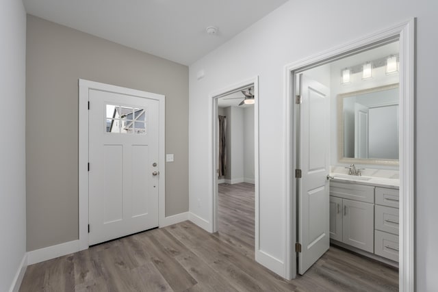 entryway featuring baseboards and wood finished floors