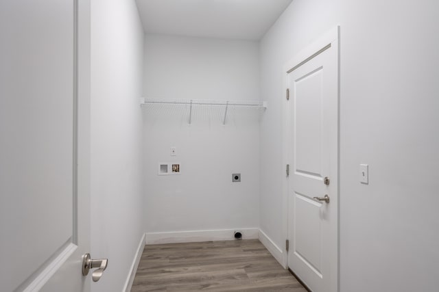 clothes washing area featuring hookup for an electric dryer, baseboards, laundry area, hookup for a washing machine, and wood finished floors