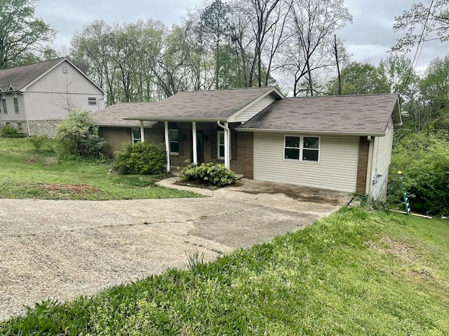 809 Chestnut Wood Ln, Chattanooga, TN 37421 - view of front of home featuring a porch, concrete driveway, a front yard, and brick siding