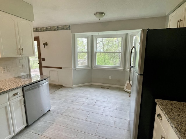 809 Chestnut Wood Ln, Chattanooga, TN 37421 - kitchen with white cabinets, tasteful backsplash, light stone counters, and appliances with stainless steel finishes