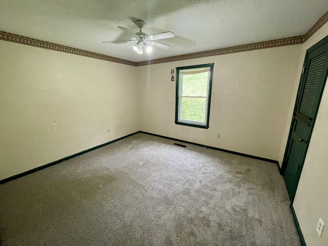 809 Chestnut Wood Ln, Chattanooga, TN 37421 - carpeted spare room with baseboards, a textured ceiling, a ceiling fan, crown molding, and visible vents