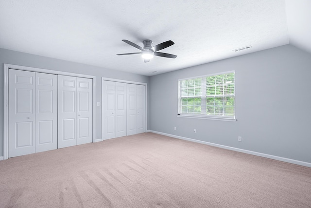 82 Andrew Rd, Ringgold, GA 30736 - unfurnished bedroom featuring two closets, carpet, baseboards, ceiling fan, and lofted ceiling