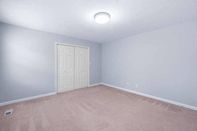 82 Andrew Rd, Ringgold, GA 30736 - unfurnished bedroom featuring a closet, carpet floors, and baseboards
