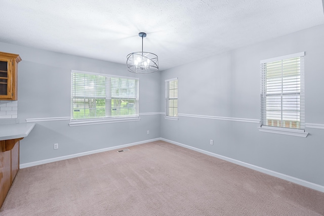 82 Andrew Rd, Ringgold, GA 30736 - unfurnished dining area featuring a chandelier, baseboards, light carpet, and a textured ceiling