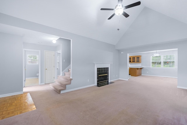 82 Andrew Rd, Ringgold, GA 30736 - unfurnished living room with a ceiling fan, high vaulted ceiling, baseboards, light carpet, and a tile fireplace