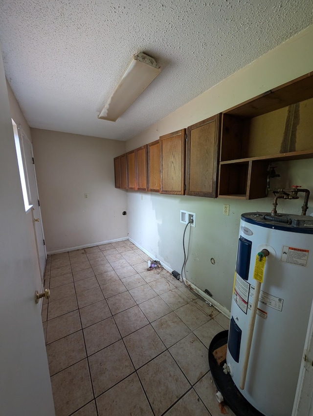 4831 Bonny Lake Ln, Chattanooga, TN 37416 - clothes washing area with water heater, tile patterned flooring, a textured ceiling, washer hookup, and cabinet space