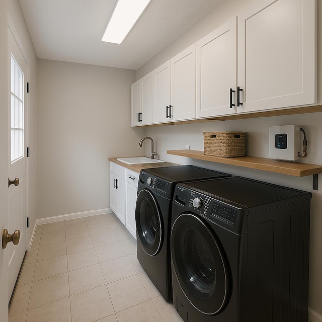 4831 Bonny Lake Ln, Chattanooga, TN 37416 - laundry area featuring light tile patterned floors, baseboards, a sink, cabinet space, and washer and clothes dryer