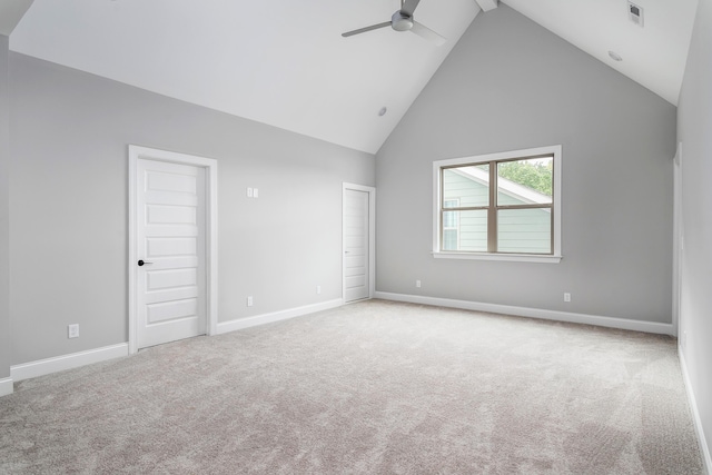 unfurnished bedroom featuring visible vents, baseboards, a ceiling fan, high vaulted ceiling, and light colored carpet