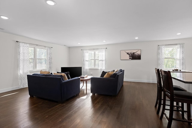 living room featuring baseboards, dark wood-style floors, and recessed lighting