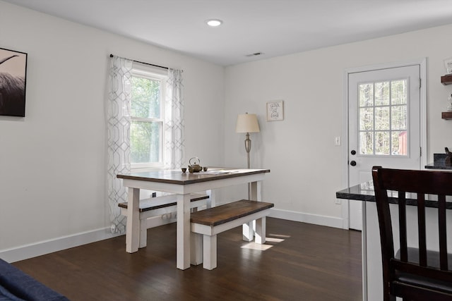 dining space with baseboards, dark wood finished floors, visible vents, and recessed lighting