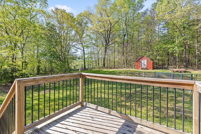 deck with an outbuilding, a storage shed, and a lawn