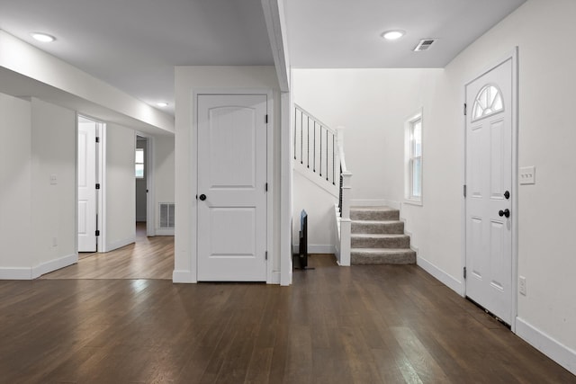 entryway featuring dark wood-type flooring, visible vents, plenty of natural light, and stairway