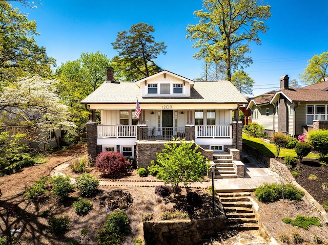 1209 Highland Dr, Chattanooga, TN 37405 - view of front of house with covered porch, a chimney, board and batten siding, stairs, and roof with shingles