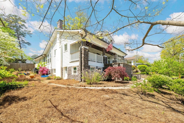 1209 Highland Dr, Chattanooga, TN 37405 - view of side of property with fence, stone siding, and a chimney