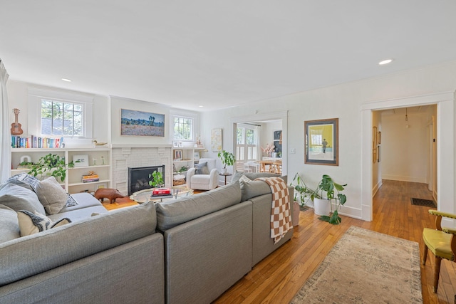 1209 Highland Dr, Chattanooga, TN 37405 - living room with light wood-style floors, a fireplace, visible vents, and recessed lighting