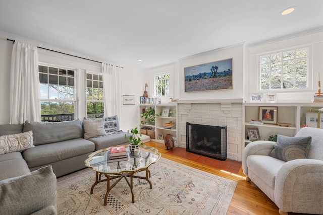 1209 Highland Dr, Chattanooga, TN 37405 - living area featuring crown molding, recessed lighting, wood finished floors, and a brick fireplace