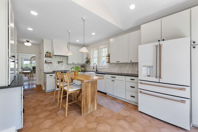 1209 Highland Dr, Chattanooga, TN 37405 - kitchen featuring white appliances, white cabinetry, a sink, premium range hood, and backsplash