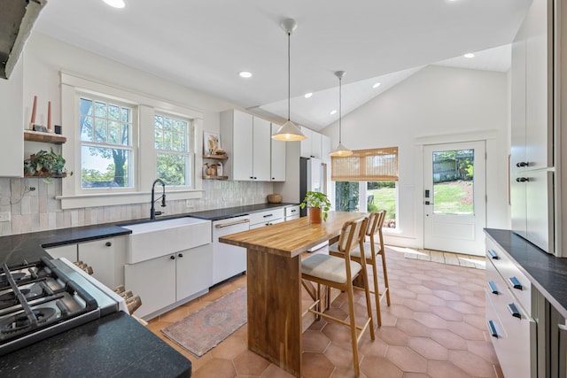 1209 Highland Dr, Chattanooga, TN 37405 - kitchen featuring dishwasher, open shelves, white cabinets, pendant lighting, and a sink
