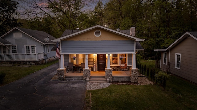 219 Martin Rd, Chattanooga, TN 37415 - back of property with a porch, a chimney, driveway, and a yard