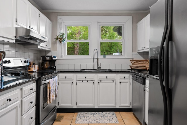 219 Martin Rd, Chattanooga, TN 37415 - kitchen with appliances with stainless steel finishes, under cabinet range hood, a sink, ornamental molding, and white cabinets
