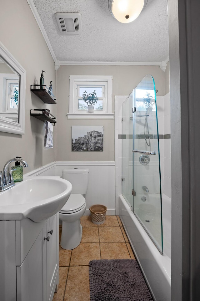 219 Martin Rd, Chattanooga, TN 37415 - full bath featuring crown molding, toilet, a textured ceiling, vanity, and bath / shower combo with glass door